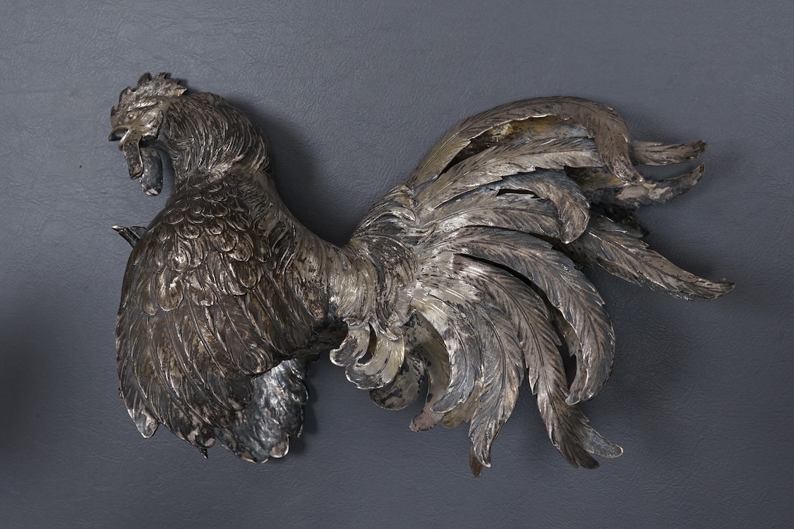 A pair of continental 800 standard white metal free-standing model fighting cockerels, tallest 16.6cm, 32.8oz.